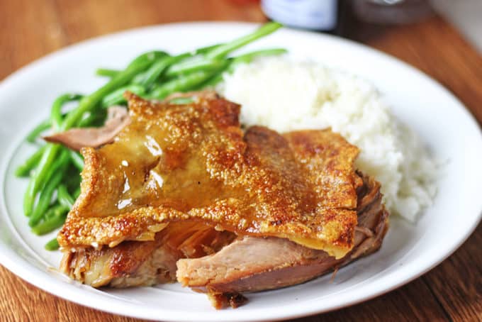 Serving of pork with rice and greens