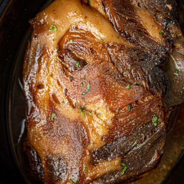 pork cooked in pot before shredding.