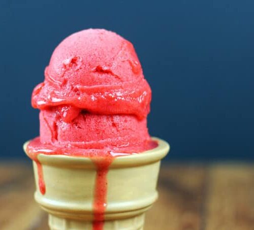 two scoops of strawberry sorbet on cone