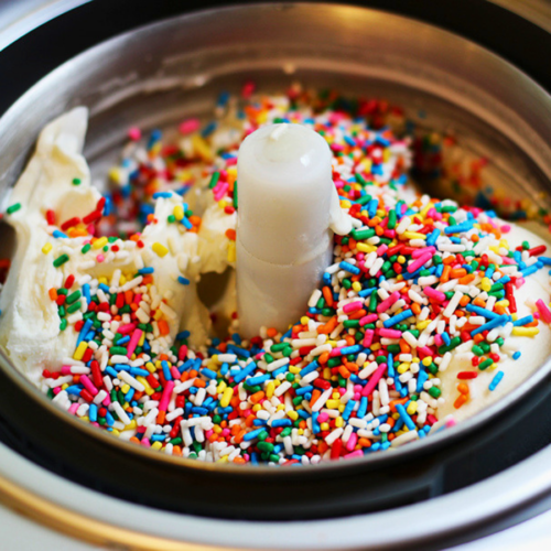 white ice cream covered in colorful sprinkles in a ice cream maker