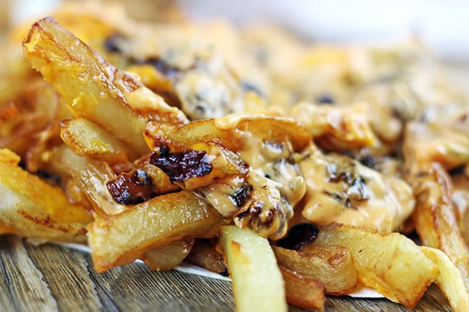 Animal-Style French Fries are fried golden brown, topped with melty American Cheese, buttery melted caramelized onions and a signature fry sauce. Serve with a fork or eat with your fingers if you dare, these fries are a cult favorite!