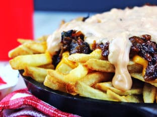 Animal-Style French Fries are fried golden brown, topped with melty American Cheese, buttery melted caramelized onions and a signature fry sauce. Serve with a fork or eat with your fingers if you dare, these fries are a cult favorite!
