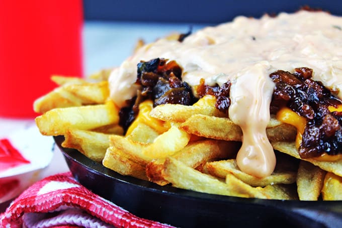 Animal-Style French Fries are fried golden brown, topped with melty American Cheese, buttery melted caramelized onions and a signature fry sauce. Serve with a fork or eat with your fingers if you dare, these fries are a cult favorite!