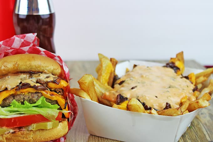 Animal-Style French Fries are fried golden brown, topped with melty American Cheese, buttery melted caramelized onions and a signature fry sauce. Serve with a fork or eat with your fingers if you dare, these fries are a cult favorite!