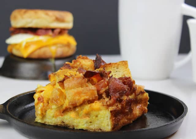 Breakfast casserole featuring eggs, bacon, and muffins.