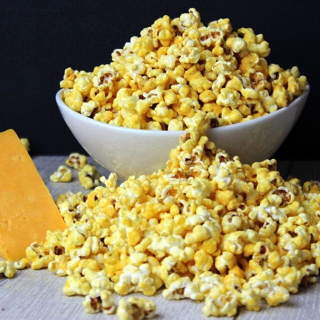 Cheesy popcorn in a bowl and on the table