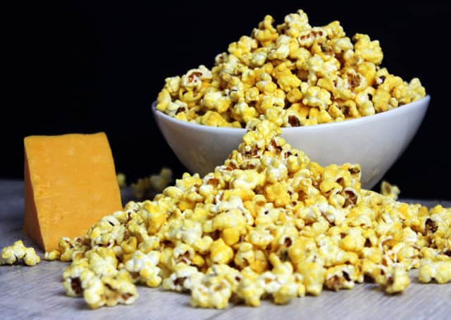 bowl and pile of Homemade Cheddar Cheese Popcorn on table