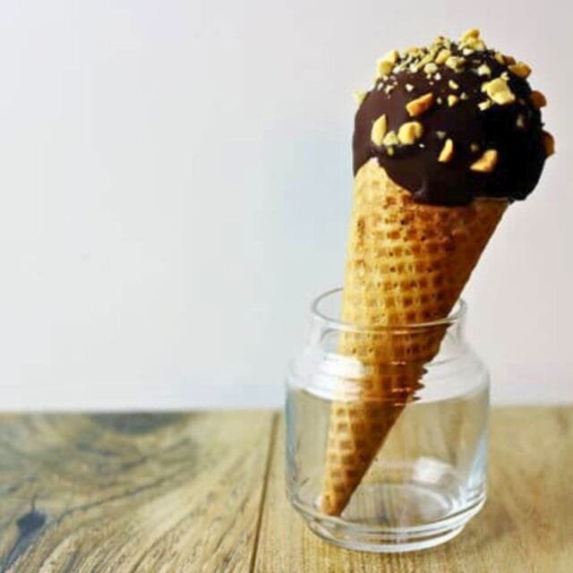 Chocolate dipped ice cream cone in small glass jar