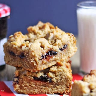 Peanut Butter & Strawberry Jelly Bars taste like a cross between a moist peanut butter cookie and a delicious PB&J sandwich. The top is crispy while the bottom layer stays cakey and fudgy! All the comfort of your favorite cookie and sandwich in one.