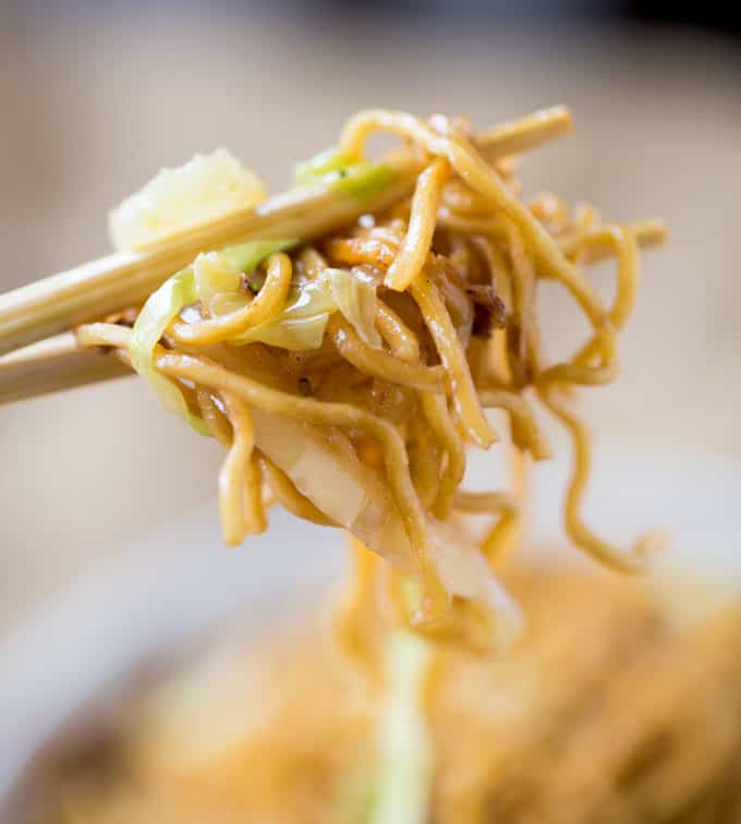 Chopsticks holding chow mein