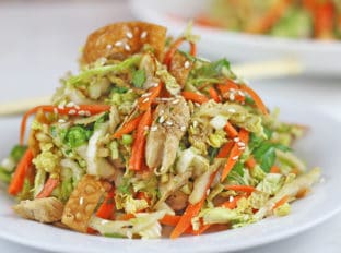 Chinese salad heaped onto white plate