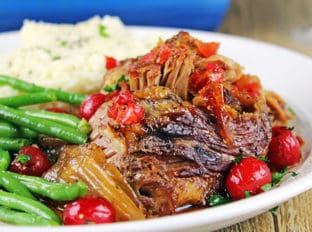Spicy & Sweet this pork is roasted over onions with chipotle peppers and cherry flavored pop along with some fun maraschino cherries until fork tender. Perfect meal for a main course, tacos, on top of nachos!