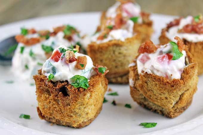 These little BLT bites are full of your favorite Bacon, Lettuce & Tomato Sandwich flavors in a small crispy bread cup. Made with cream cheese, sour cream, tomatoes, bacon and parsley, they are a fantastic holiday or football party food!