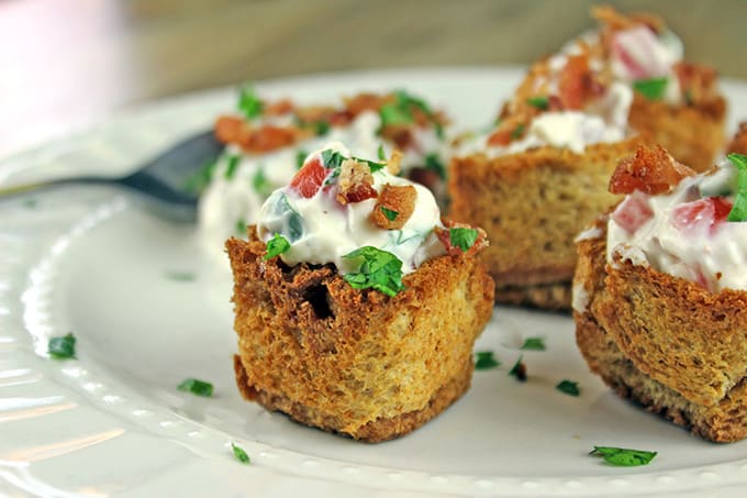 These little BLT bites are full of your favorite Bacon, Lettuce & Tomato Sandwich flavors in a small crispy bread cup. Made with cream cheese, sour cream, tomatoes, bacon and parsley, they are a fantastic holiday or football party food!