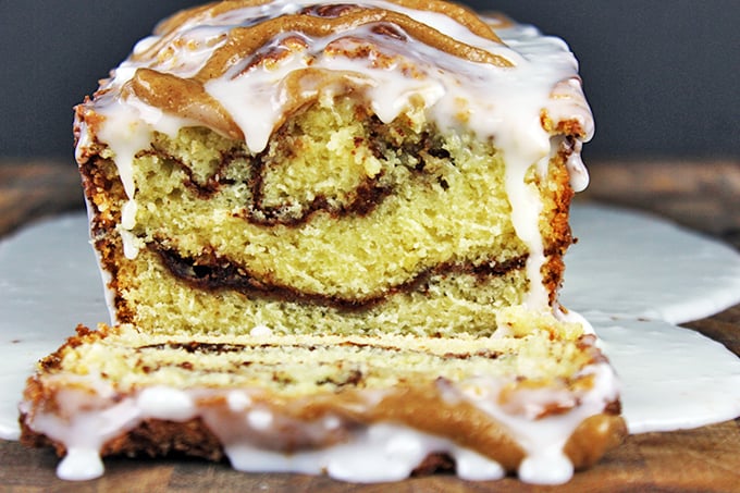 Tender, Rich Cinnamon Roll Pound Cake drenched in Cinnamon Swirl Icing. Easy to make, addicting to eat and perfect for your morning cup of coffee!