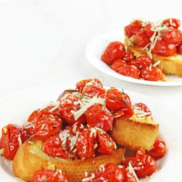Hold on to those fleeting memories of summer with these amazing Roasted Garlic Tomatoes made in just 15 minutes and versatile enough to be an appetizer, part of a main course or a fantastic spread on a sandwich!