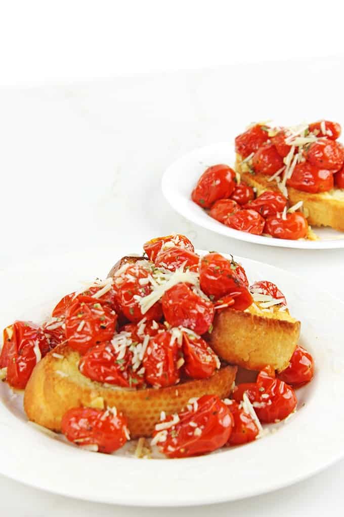 Hold on to those fleeting memories of summer with these amazing Roasted Garlic Tomatoes made in just 15 minutes and versatile enough to be an appetizer, part of a main course or a fantastic spread on a sandwich!