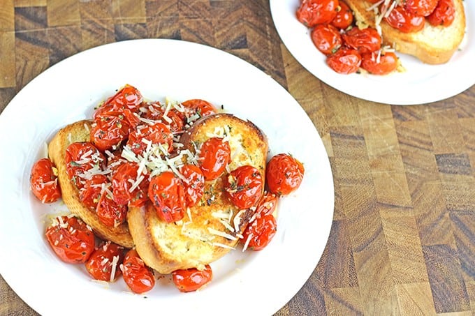 Hold on to those fleeting memories of summer with these amazing Roasted Garlic Tomatoes made in just 15 minutes and versatile enough to be an appetizer, part of a main course or a fantastic spread on a sandwich!