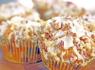 A delicious pumpkin muffin topped with a pecan streusel crunch and drizzled with a maple icing. It is all the amazing flavors of fall all rolled in to a delicious breakfast treat.