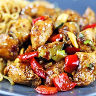 plate of Kung pao chicken and veggies with chow mein