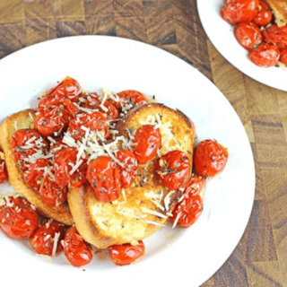 tomatoes and toast on a dish with cheese on top