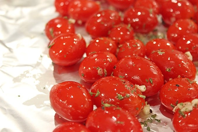 Hold on to those fleeting memories of summer with these amazing Roasted Garlic Tomatoes made in just 15 minutes and versatile enough to be an appetizer, part of a main course or a fantastic spread on a sandwich!