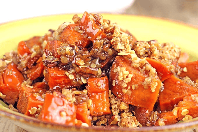 Close up of chopped and baked sweet potatoes with sweetened oat topping