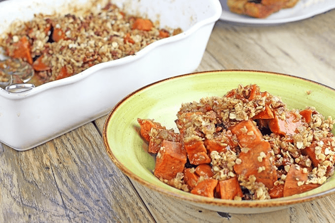 Plated sweet potato dish with full baking dish in the background