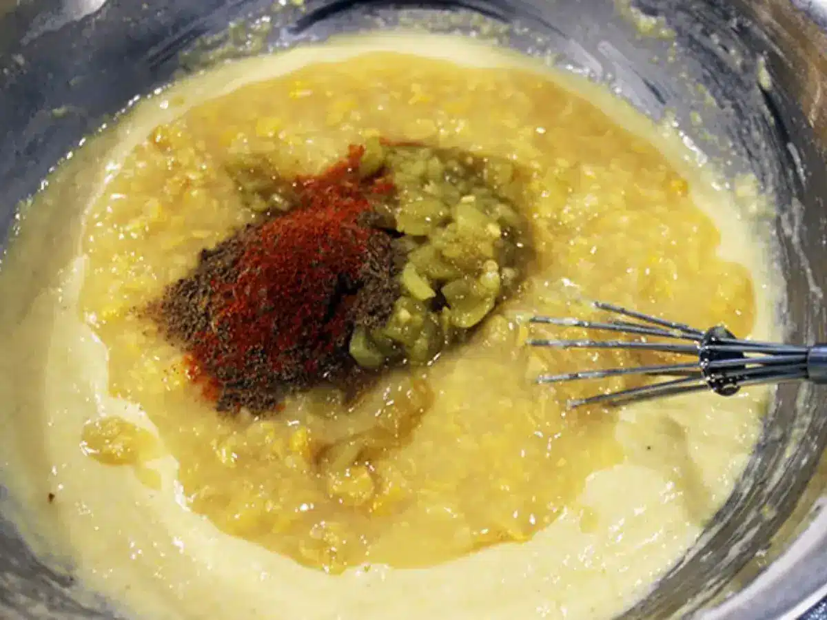 enchilada sauce ingredients in a bowl with a whisk