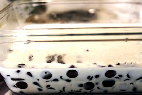 Chocolate chips and cream in a glass container