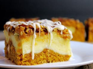Delicious pumpkin bread with a layer of sweet cheesecake topped with crunchy pecans. Everything you could want in a Fall themed dessert and more. It's easy enough to remember the four ingredients and it works for when you don't need that super thick, rich cheesecake. The addition of the chopped pecans adds a crunchy element to the soft cake, and creamy cheesecake and icing layers.