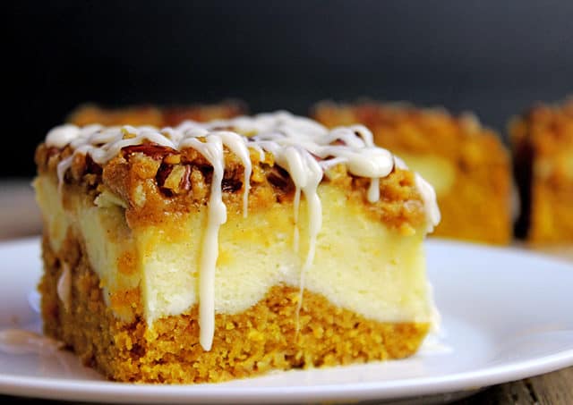 Delicious pumpkin bread with a layer of sweet cheesecake topped with crunchy pecans. Everything you could want in a Fall themed dessert and more. It's easy enough to remember the four ingredients and it works for when you don't need that super thick, rich cheesecake. The addition of the chopped pecans adds a crunchy element to the soft cake, and creamy cheesecake and icing layers.