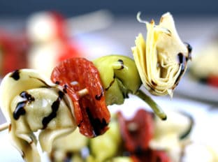 Italian Antipasto Skewers: The spice of the pepperoni, the sweet vinegar of the balsamic glaze, the tender tortellini filled with ricotta and spinach, the briney flavor of the pepperoncini and the artichoke heart. This skewer is going to be a solid contender for favorite bite at your next party!