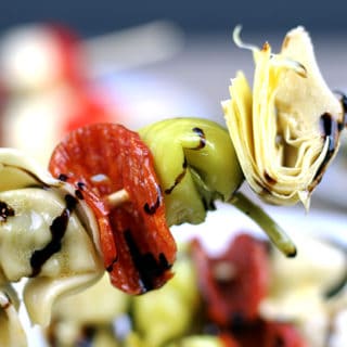 Italian Antipasto Skewers: The spice of the pepperoni, the sweet vinegar of the balsamic glaze, the tender tortellini filled with ricotta and spinach, the briney flavor of the pepperoncini and the artichoke heart. This skewer is going to be a solid contender for favorite bite at your next party!