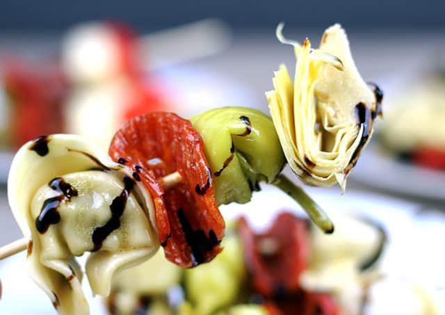 Italian Antipasto Skewers: The spice of the pepperoni, the sweet vinegar of the balsamic glaze, the tender tortellini filled with ricotta and spinach, the briney flavor of the pepperoncini and the artichoke heart. This skewer is going to be a solid contender for favorite bite at your next party!