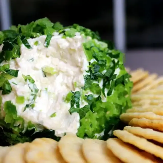 cheese ball with crackers on a plate