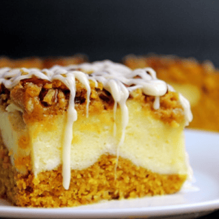 individual cheesecake bars on a plate with blurred bars in backround