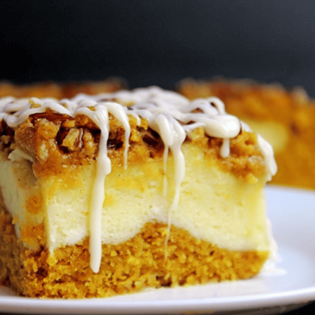 individual cheesecake bars on a plate with blurred bars in backround