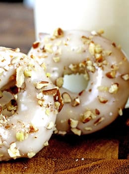 Baked Mini Pumpkin Donuts with Maple Icing. Tender Pumpkin baked donuts that are made in one bowl and bake in 8 minutes are covered in a quick two ingredient maple icing and finally are topped with crunchy pecans. It will look like you're a pro in the kitchen but these are a cinch to make!