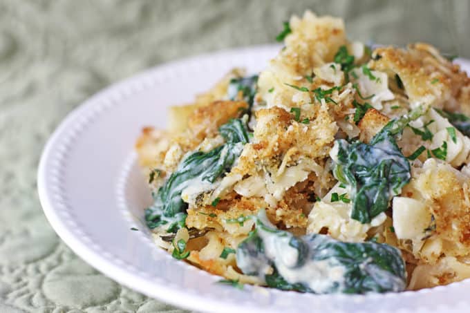 Your favorite Spinach and Artichoke Dip in a pasta bake with a Parmesan Buttery Cracker crust! Made with Mozzarella, Parmesan, cream cheese and sour cream with fresh spinach and artichoke hearts.