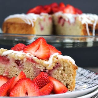 strawberry cake with a berry topping and frosting.