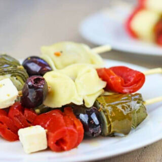 Party skewers with olives, feta cheese, and grape leaves