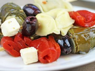 Your guests will love these cocktail party appetizers! Garlicky tortellini, stuffed grape leaves, feta, olives and peppers with almost no effort!