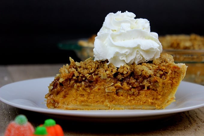 Slice of pie on plate with whipped cream. 