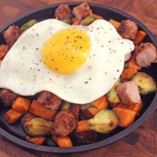 skillet filled with veggies, sausage, and egg