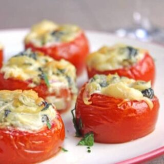Baked Tomatoes on a white serving plate.