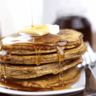 fluffy holiday spiced pancakes stacked up on a plate