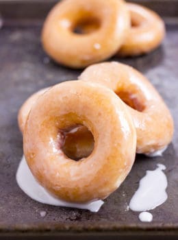 The Original Krispy Kreme Glazed Yeast Doughnut you know and love and now you can make them at home and eat them fresh! These doughnuts are best right after the glaze dries!