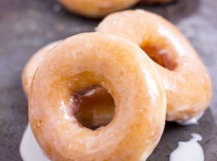 The Original Krispy Kreme Glazed Yeast Doughnut you know and love and now you can make them at home and eat them fresh! These doughnuts are best right after the glaze dries!