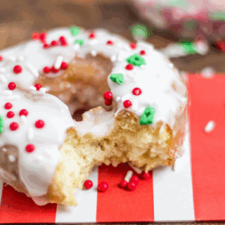 glazed old fashioned donut with sprinkles on a striped napkin